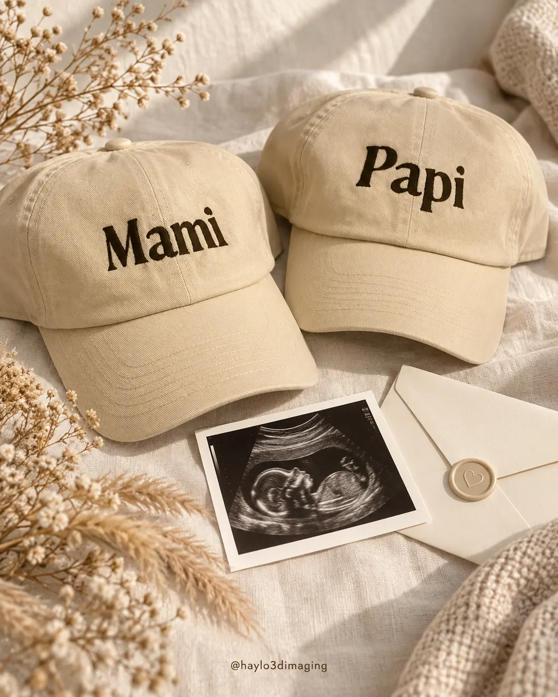 Mami and Papi hats arranged beside an ultrasound image and keepsake envelope